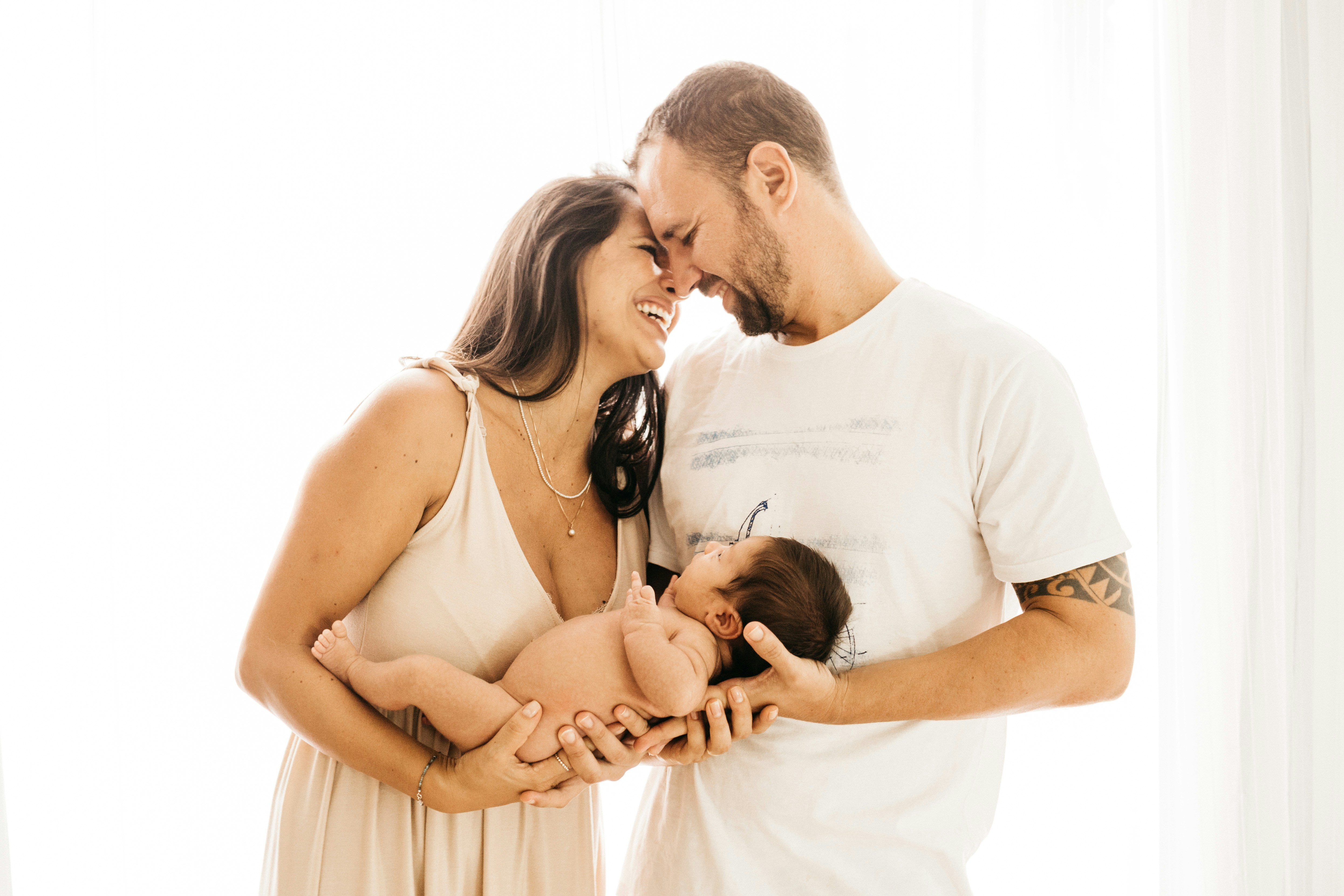 New parents tenderly holding their newborn baby — the moment healthcare matters most