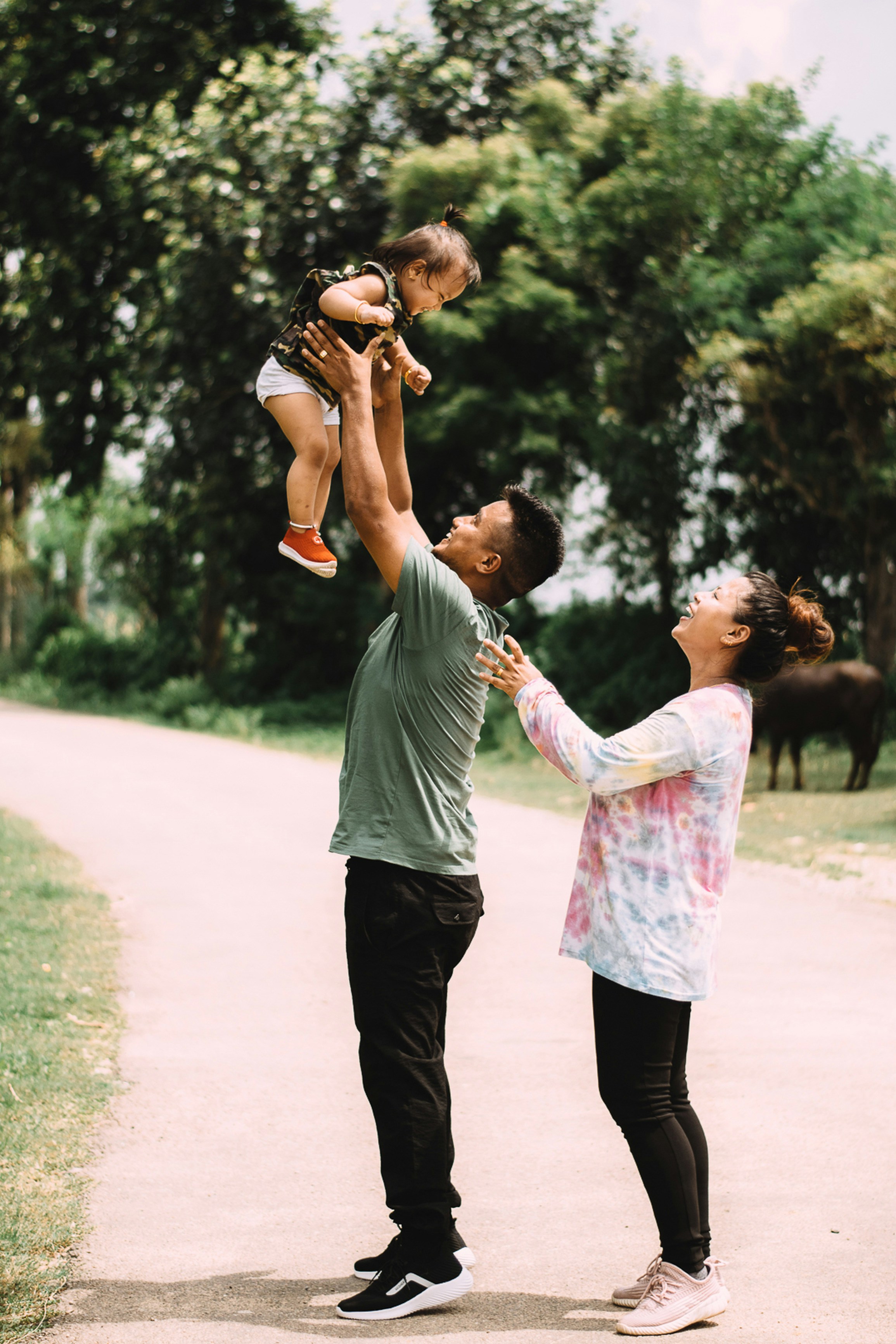 Happy Asian family playing joyfully outdoors