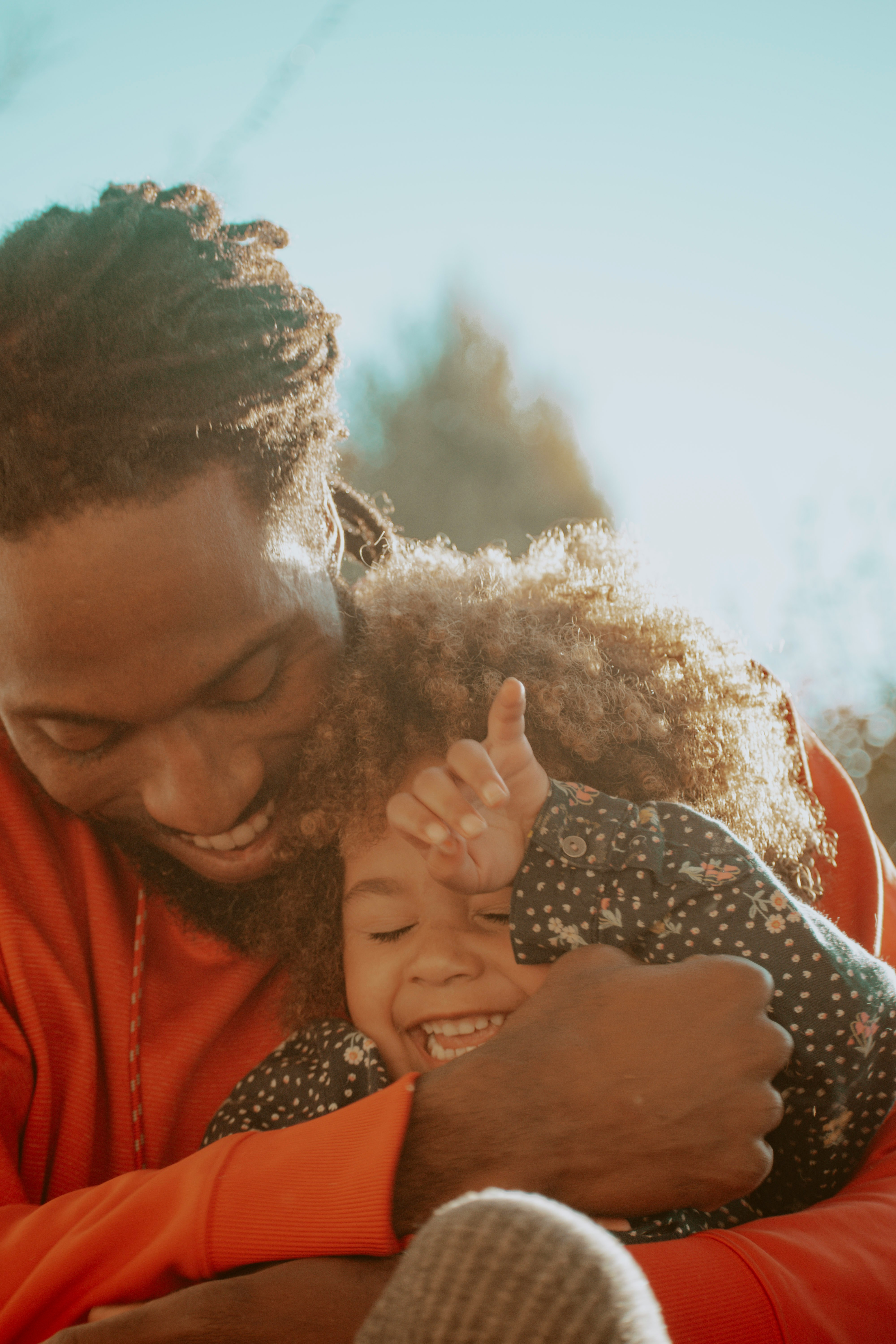 Father joyfully hugging his laughing child