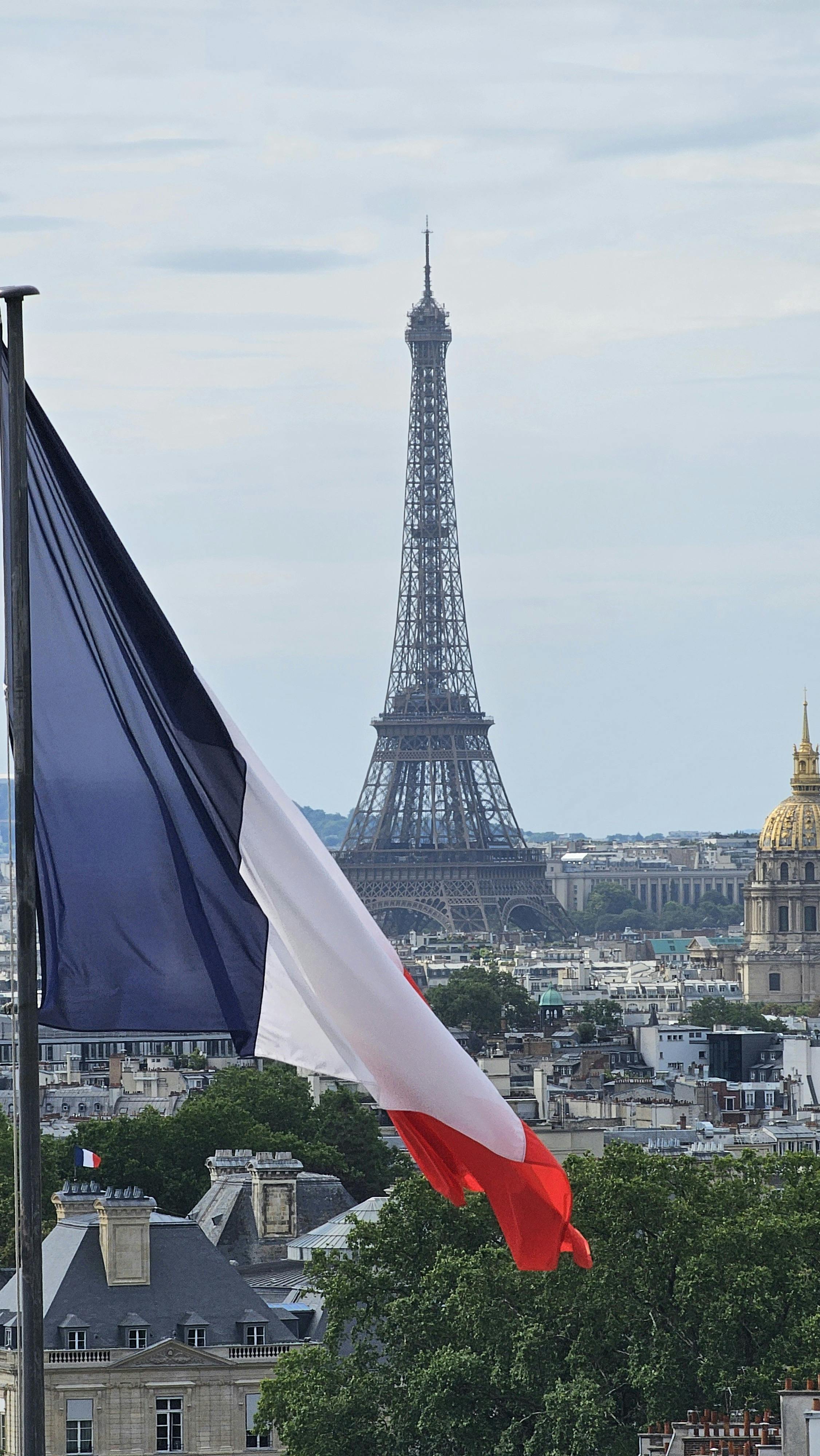 Eiffel Tower and French flag in Paris, France